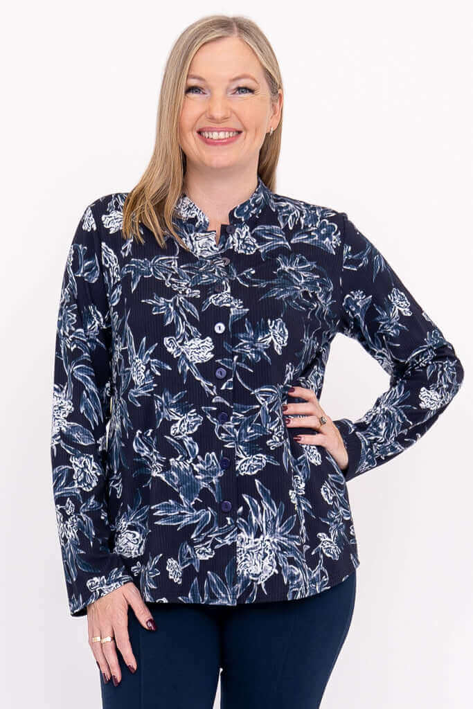 Woman wearing navy floral mandarin collar top, facing forward