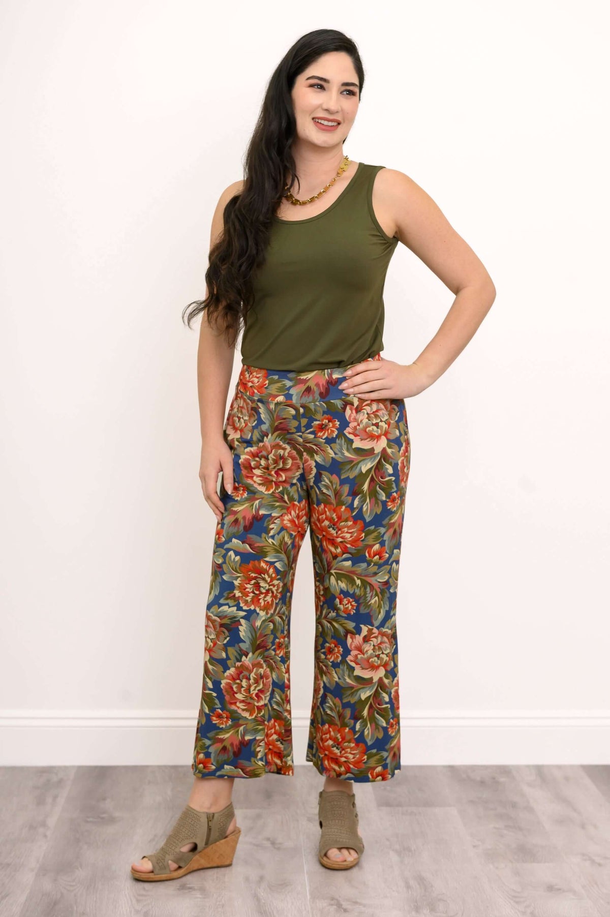 Woman wearing olive tank top and colorful wide leg floral pants