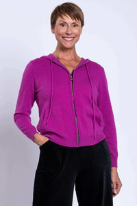 Model wearing a vibrant purple zip-up hoodie with drawstrings and front pockets, smiling at the camera