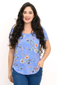 Smiling woman wearing a blue floral short sleeve tee with relaxed fit