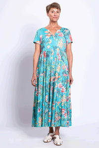 Woman wearing a turquoise floral maxi dress with short sleeves and v-notch neckline