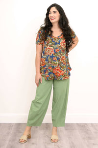 Woman looking to the side, smiling while wearing floral v-neck bamboo top