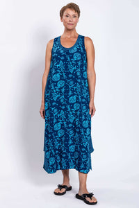 Smiling woman modeling blue floral Ari tank dress with wide shoulder straps