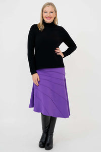 Woman modeling Beverly Skirt in purple with hands on hips, front view