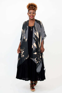 Woman modeling Darcy wrap with hands relaxed, showing draped front style