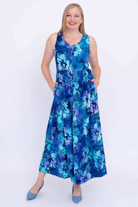 Woman modeling a sleeveless blue floral maxi dress with a button-up front