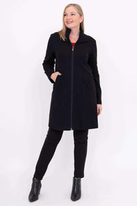 Woman modeling black Tracy Coat over black pants and red top