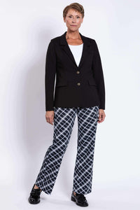Woman modeling black blazer and checked pants, relaxed stance, front view