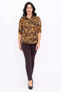 Woman in leaf print bamboo-linen blouse walking forward, front view