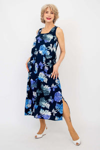Woman modeling a sleeveless navy blue floral dress with square neckline and calf-length hem