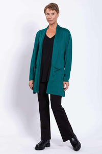 Woman modeling teal open cardigan, black outfit, standing at slight angle