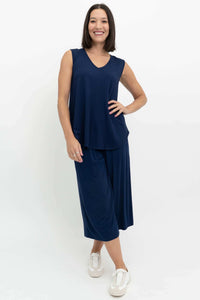 Woman posing in a navy sleeveless bamboo top and matching pants, front angle