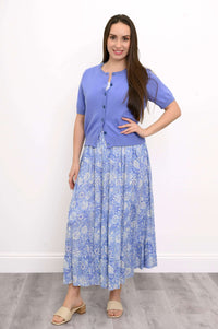 Woman posing in the Roma blue floral tiered skirt and blue cardigan