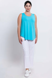Woman posing in aqua blue sleeveless Jazz tank and white pants