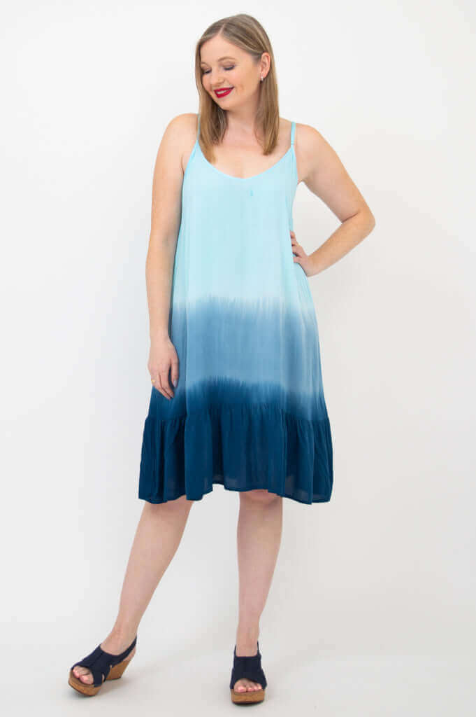 Woman posing in a blue ombre sleeveless dress with scooped neckline and relaxed fit