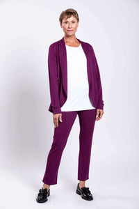 Woman posing in plum purple French Terry jacket outfit with one hand on hip