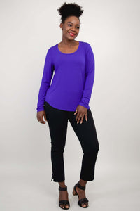 Woman posing in purple bamboo long sleeve top and black cropped pants