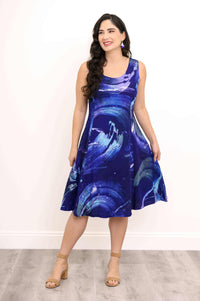 Woman smiling in abstract blue swirl sleeveless A-line dress