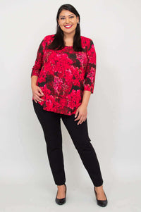 Woman smiling in fuchsia swirl bamboo top with hand on hip