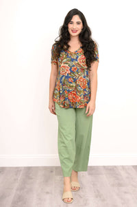 Woman standing in Jackie Bamboo V-Neck Floral Top and green pants
