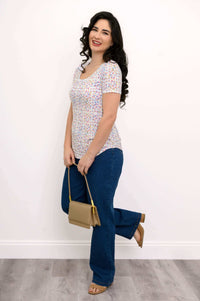 Full-length view of woman in Tessa Tee, blue jeans, tan purse and sandals