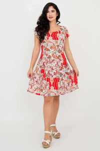 Woman twirling in a red and white paisley print short sleeve dress