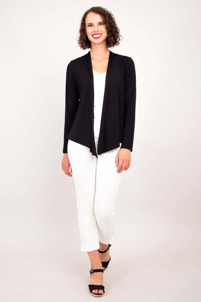 Woman walking forward in a black cardigan with pointed front panels