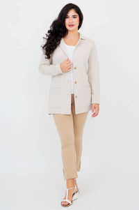 Woman walking forward in the Margaret light beige sweater jacket, front view