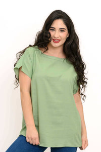 Woman wearing a light green relaxed fit tee with dolman cap sleeves and straight silhouette