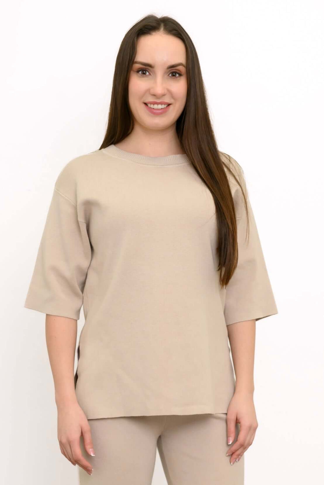 Woman wearing the Bailey Sweater in soft beige, short sleeves, and relaxed fit