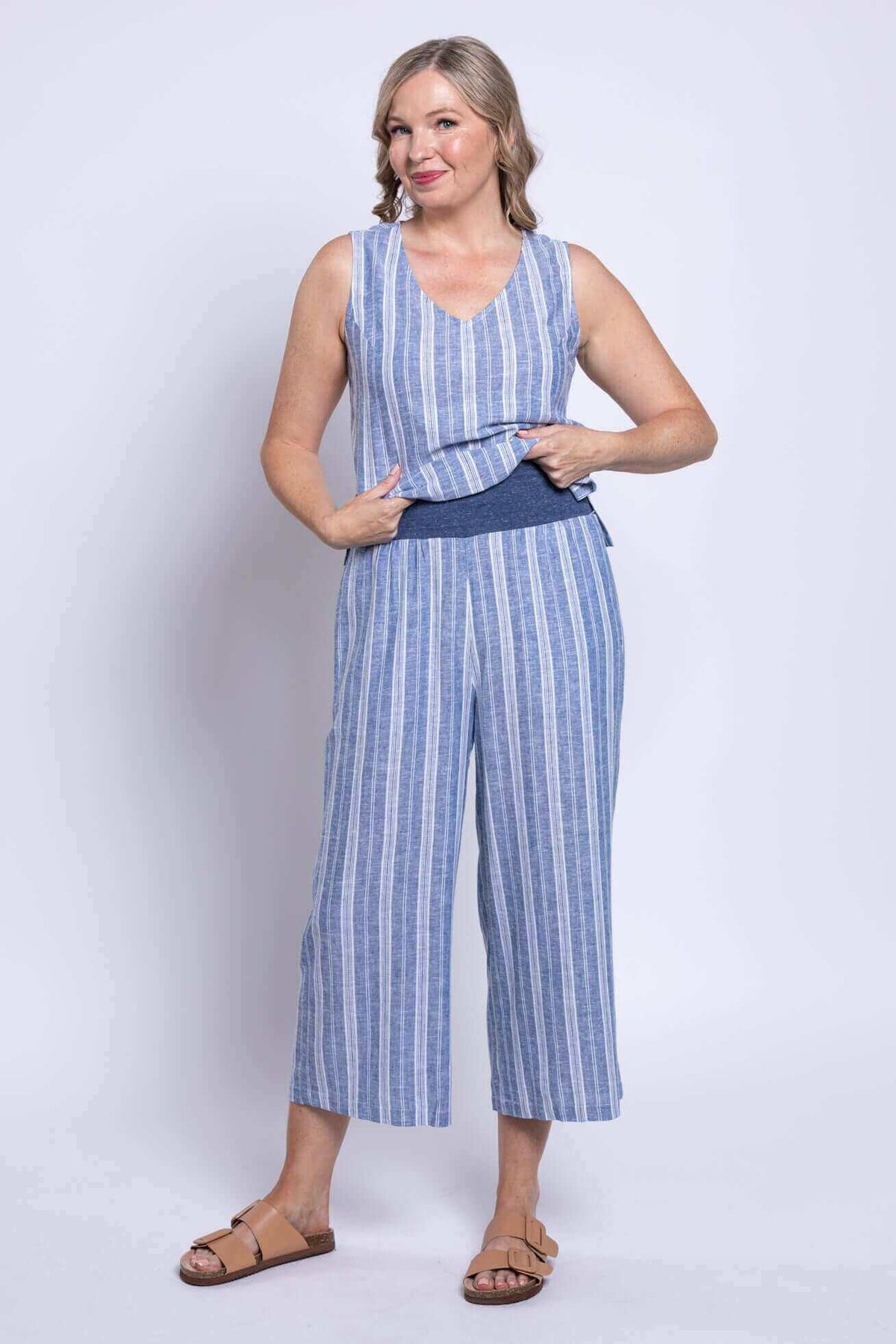 Woman wearing Landon cropped capri pants and matching top, holding waistband