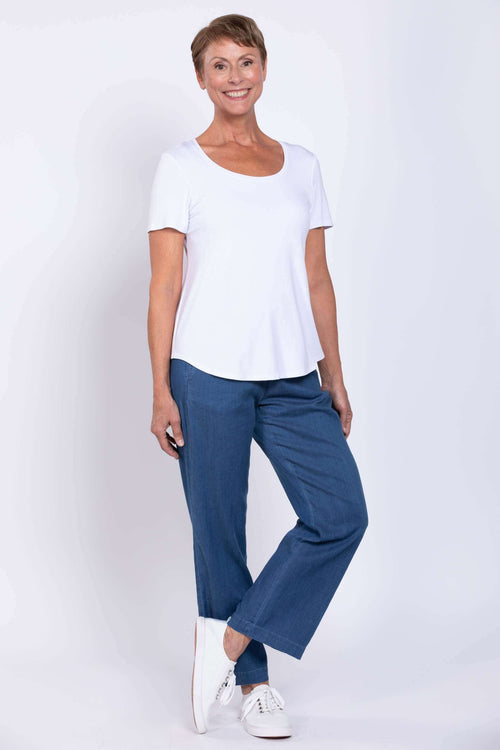 Woman wearing Marla Tencel Pants styled with a white t-shirt and sneakers