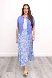 Woman wearing the Roma blue floral tiered skirt with a blue cardigan