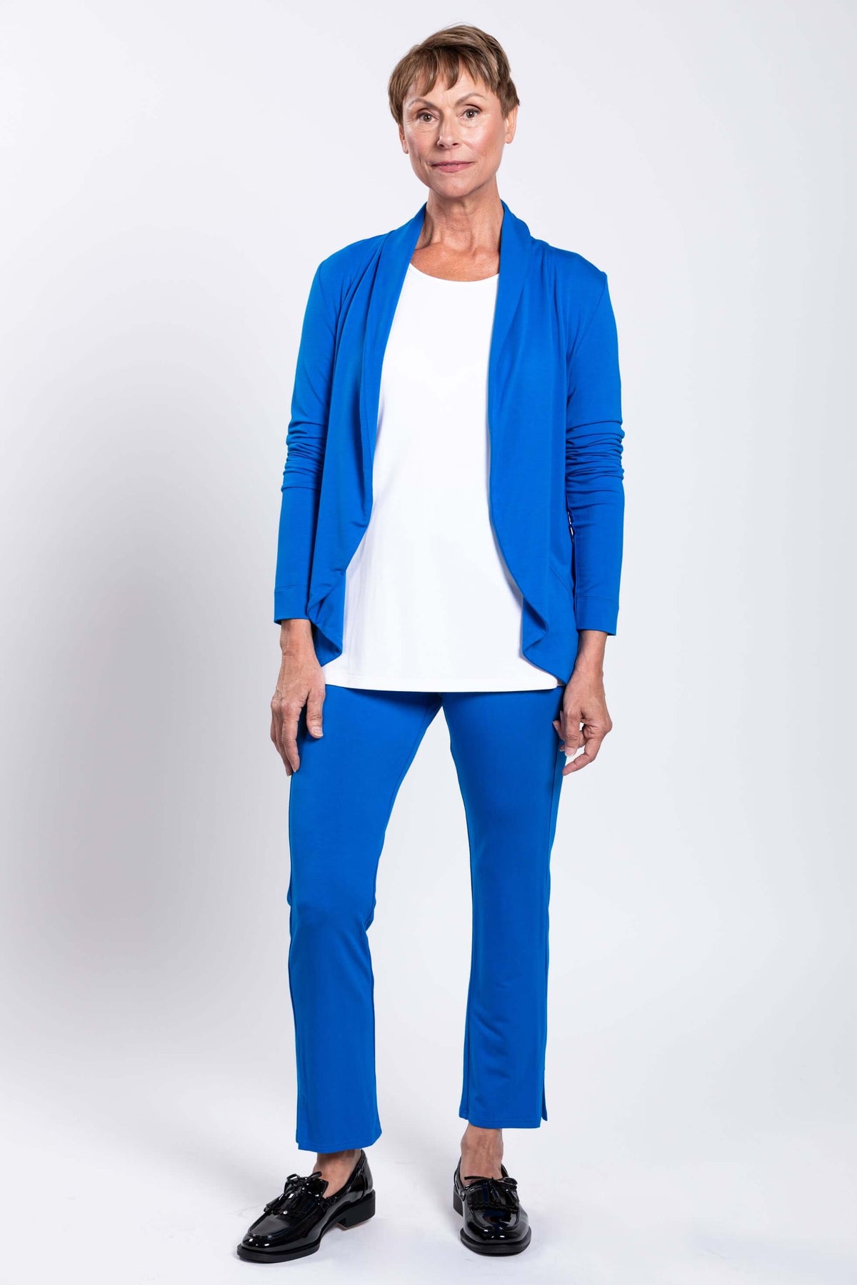 Woman wearing Sarina Pant and matching blue jacket, white top, black shoes