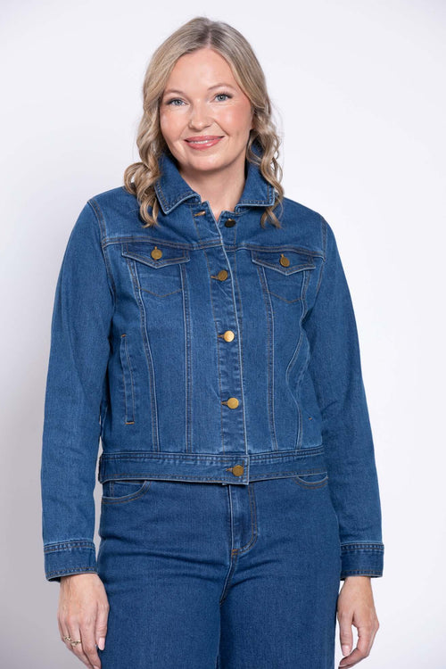Woman wearing Vilmar classic blue denim jacket, buttoned up, with curly blonde hair