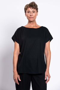 Woman wearing a black short-sleeve linen blend tee with a relaxed fit, front view