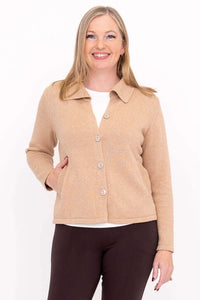 Woman wearing a hip-length beige cardigan with a collared neckline
