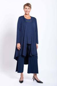 Woman wearing a navy blue duster with subtle embellishments and wide leg pants