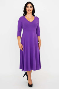 Woman wearing a purple midi-length dress with three-quarter sleeves and V-neckline