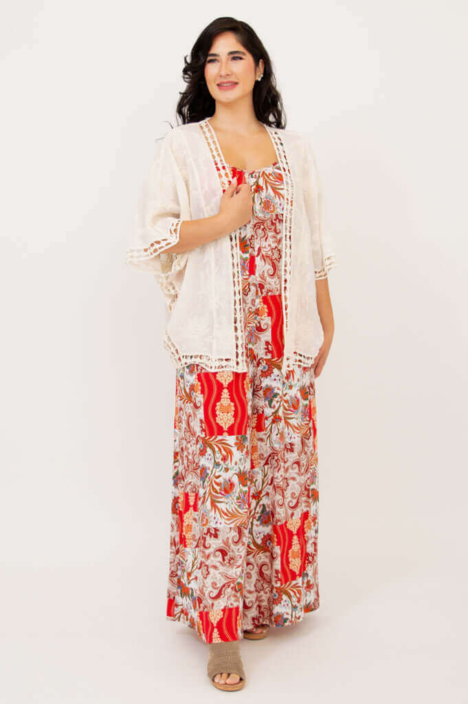 Woman wearing a white open kimono over a red and cream floral jumpsuit