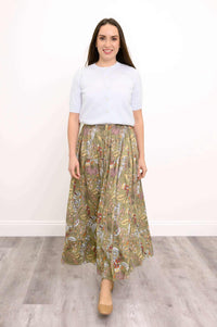 Woman wearing a white top and floral Roma skirt, front view