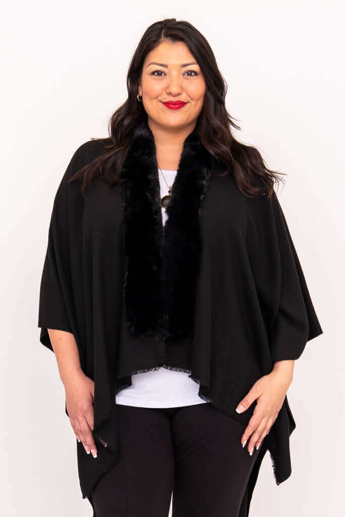Woman wearing a black wrap with faux fur collar, facing forward