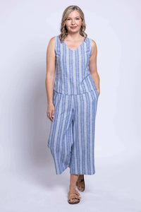 Woman posing in blue and white striped sleeveless cropped top and wide leg pants