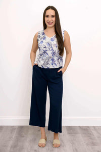 Full body view of woman in blue floral cropped tank and navy pants