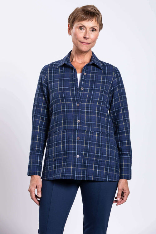 Woman wearing a blue plaid cotton jacket with shirt collar, front view