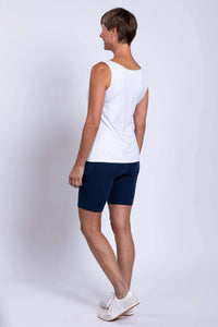 Woman wearing navy Robson Shorts and white sleeveless top, back view