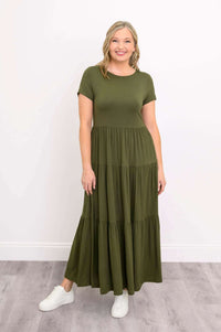 Woman wearing olive green tiered maxi dress with white sneakers