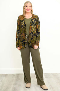 Woman wearing matching olive green pants, shirt, and patterned jacket, smiling