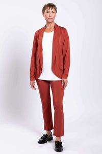 Full body image of a complete monochromatic outfit in copper rust stretch bamboo top and trouser set.
