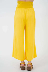 Yellow wide-leg cropped capri pants with deep waistband, rear view closeup